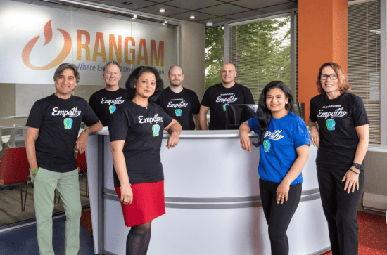 A group of eight people wearing “Empathy” t-shirts standing in a reception